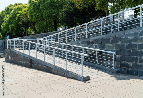 A wheelchair ramp, an inclined plane installed in addition to or instead of stairs photo