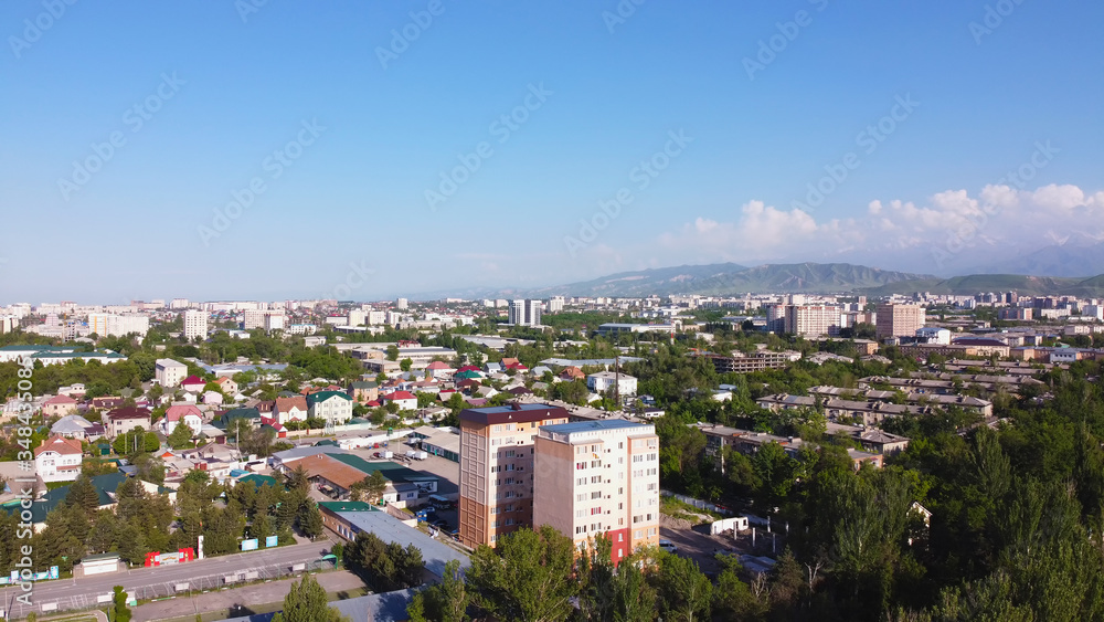 Scenary arial city landscape with sky and mountains.