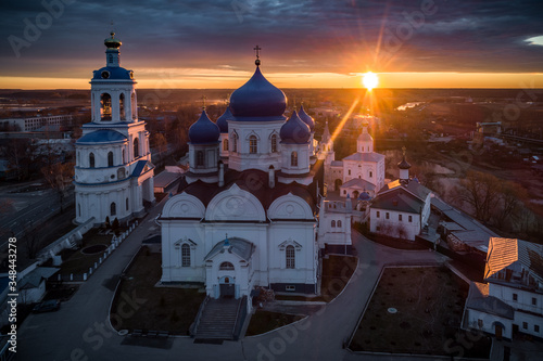 Sun rising over the All-Saints Bell Tower and Our Lady of Bogolyubovo Church in the village of Bogolyubovo, Vladimir region, Russia
