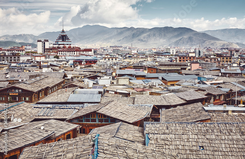 Fototapeta Roofs of Dukezong, Shangri La old town skyline, color toning applied, Diqing Tibetan Autonomous Prefecture, China