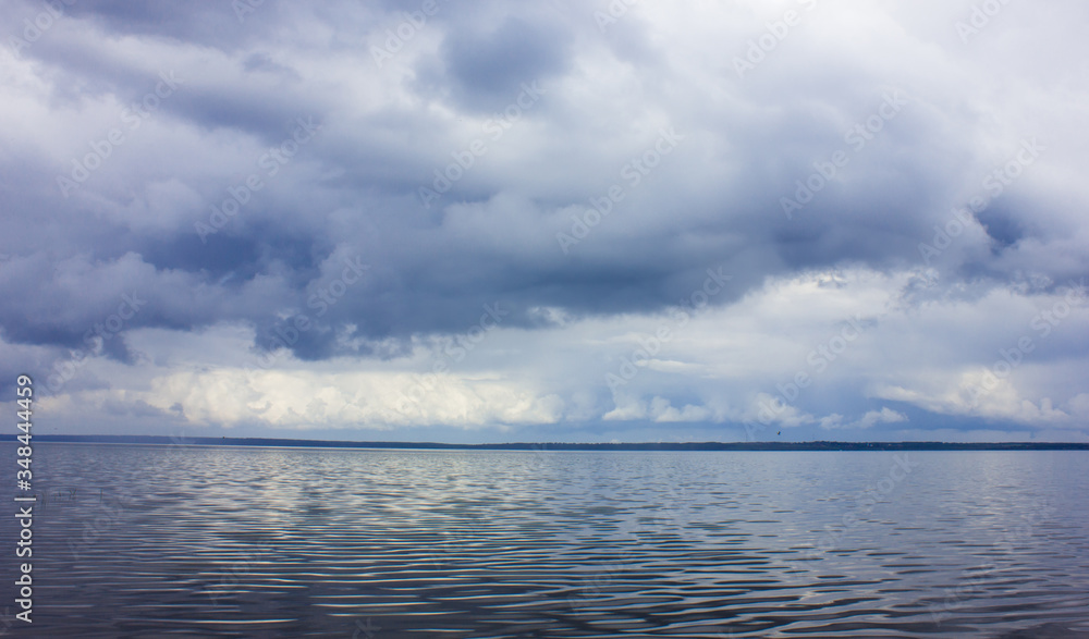 Big lake and clouds. Cloudy weather on the lake. Hurricane.