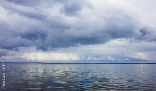 Big lake and clouds. Cloudy weather on the lake. Hurricane.