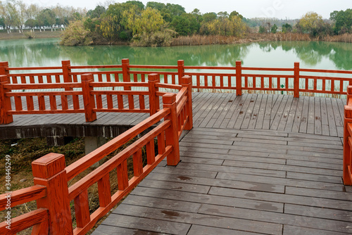 Wooden bridge over little river in city park