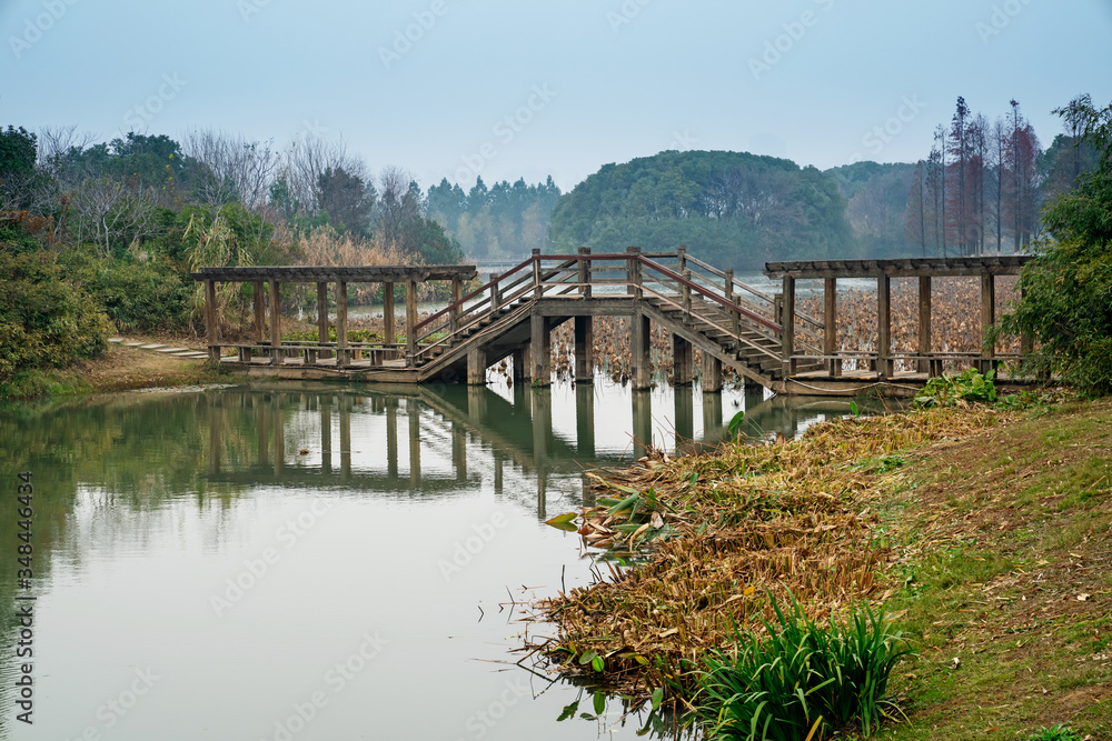 Wooden bridge over little river in city park