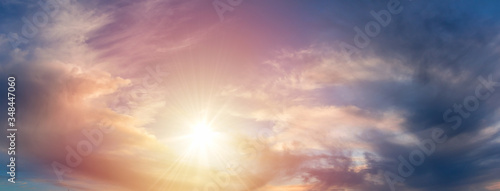 Panoramic view to nice sunset cumulus cloud on blue sky with sun