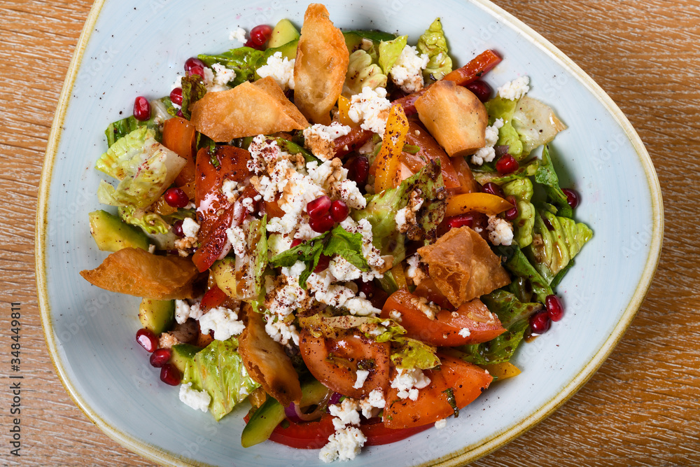 Fattoush is a Levantine salad made from toasted or fried pieces of khubz combined with mixed greens Fattoush is a Levantine salad made from toasted or fried pieces of khubz combined with mixed greens