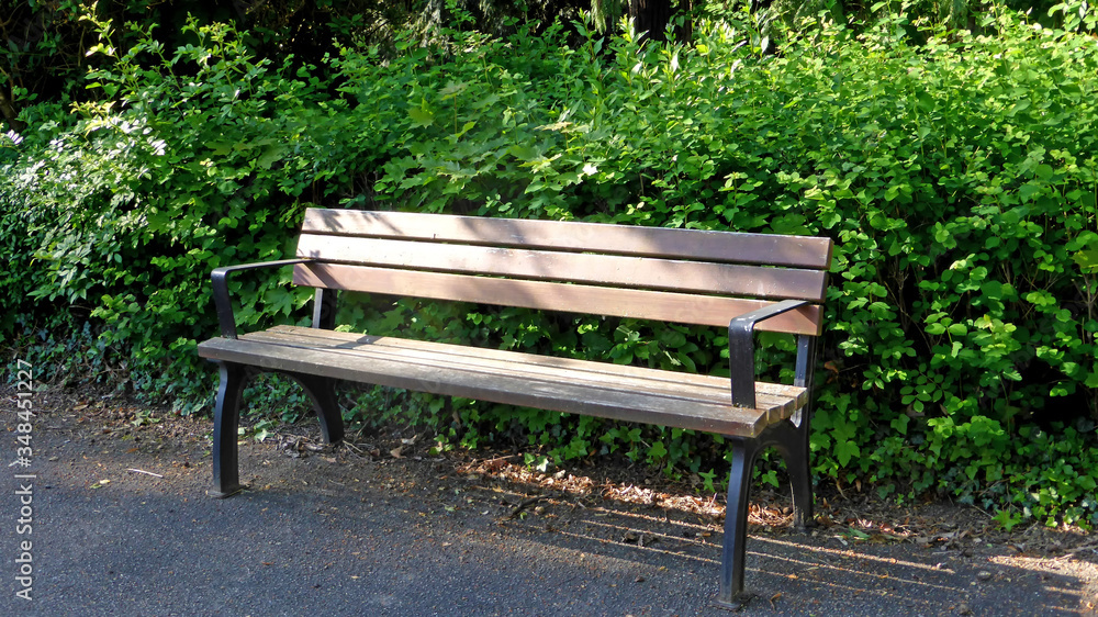 empty park bench with sun and shadow empty park bench with sun and shadow