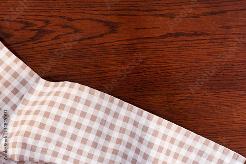 Kitchen towel or napkin over the wooden table. Close up.
