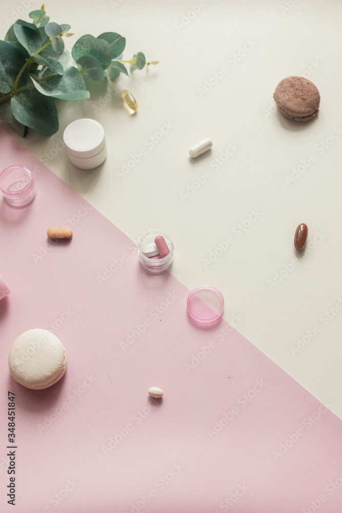 A close-up top view of various pills and macaroni on yellow and pink background.Medical, pharmacy and health care concept. Pill box. Dietary supplements and vitamins. Copy place for text or logo A close-up top view of various pills and macaroni on yellow and pink background.Medical, pharmacy and health care concept. Pill box. Dietary supplements and vitamins. Copy place for text or logo