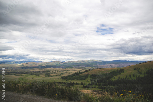 Hills view with clouds and green fields in Yellowstone National Park United States with wallpaper concept for travelers and copy space in the wold famous destination in the world with natural beauty