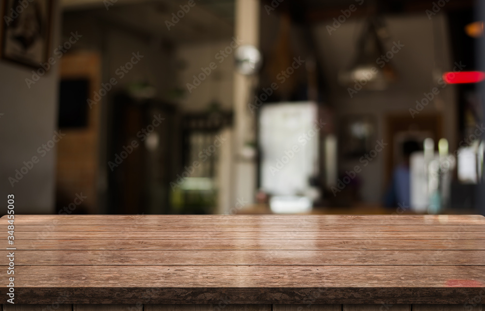 Empty old wood table top with bokeh coffee shop interior background.g Empty old wood table top with bokeh coffee shop interior background.g