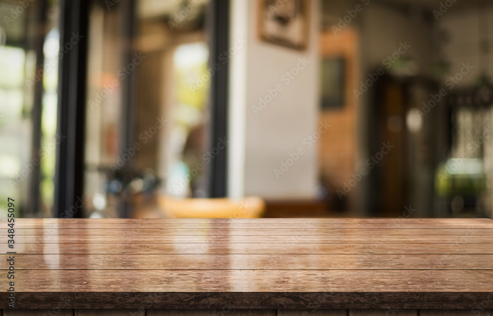 Empty old wood table top with bokeh coffee shop interior background.