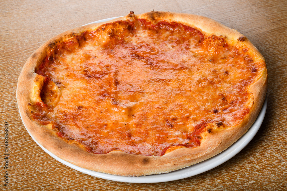 Pizza Margherita on brown table background, top view. Pizza Margarita with Tomatoes, mozzarella Pizza Margherita on brown table background, top view. Pizza Margarita with Tomatoes, mozzarella