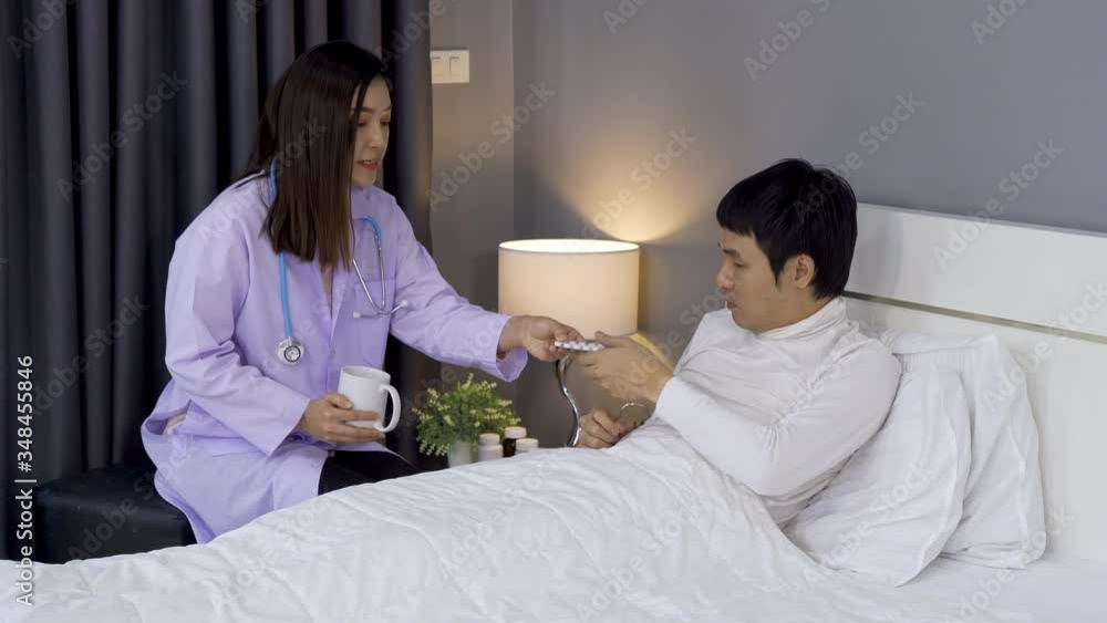 Doctor explaining the pills to male patient in a bed Doctor explaining the pills to male patient in a bed