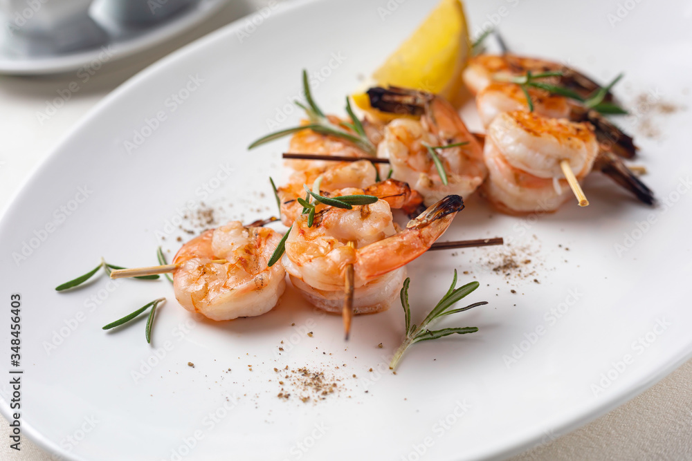 grilled shrimp on a white plate in a restaurant grilled shrimp on a white plate in a restaurant