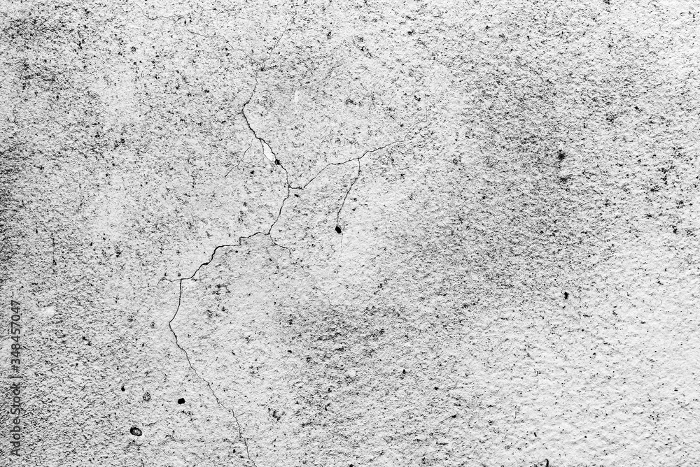 Fototapeta premium Texture of a concrete wall with cracks and scratches which can be used as a background