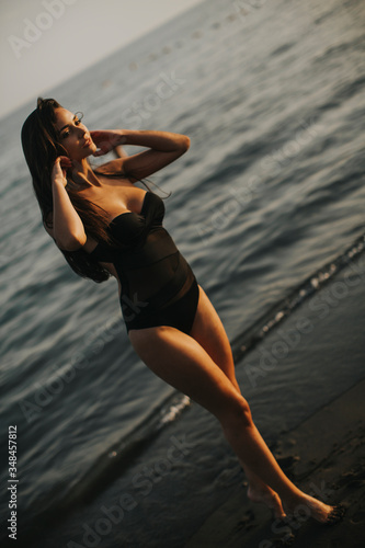 Young woman walking in wate...