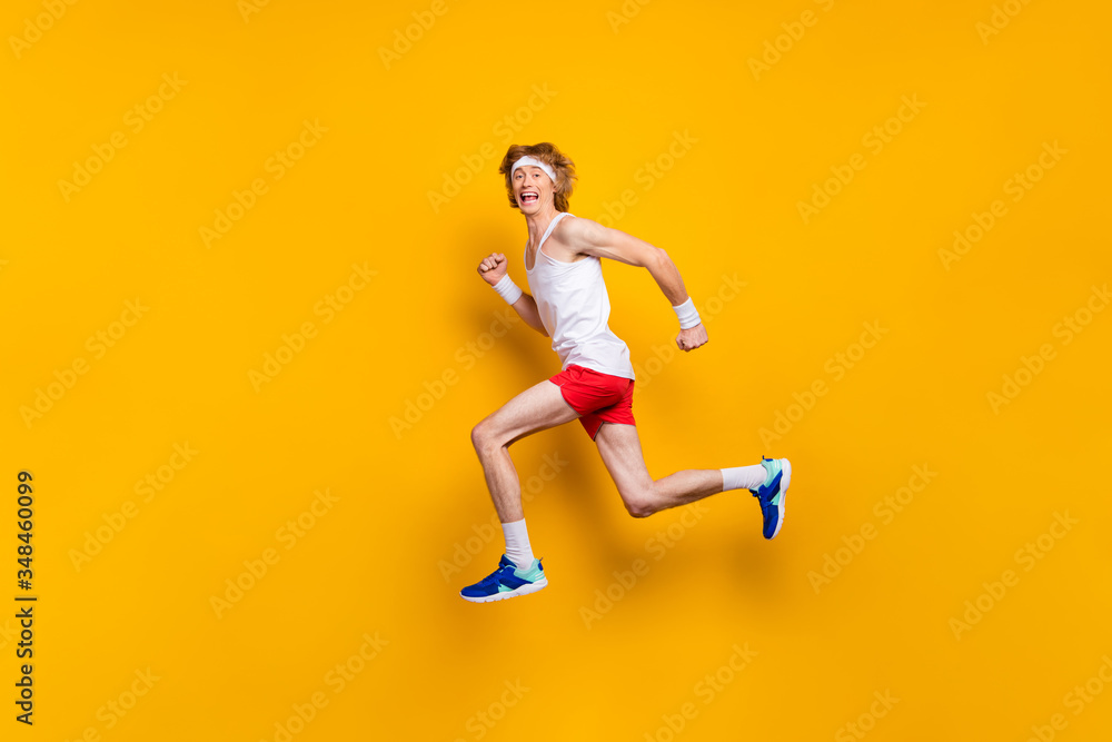 Full length body size view of nice funky glad excited cheerful cheery motivated guy jumping running fast hurry rush marathon isolated over bright vivid shine vibrant yellow color background Full length body size view of nice funky glad excited cheerful cheery motivated guy jumping running fast hurry rush marathon isolated over bright vivid shine vibrant yellow color background