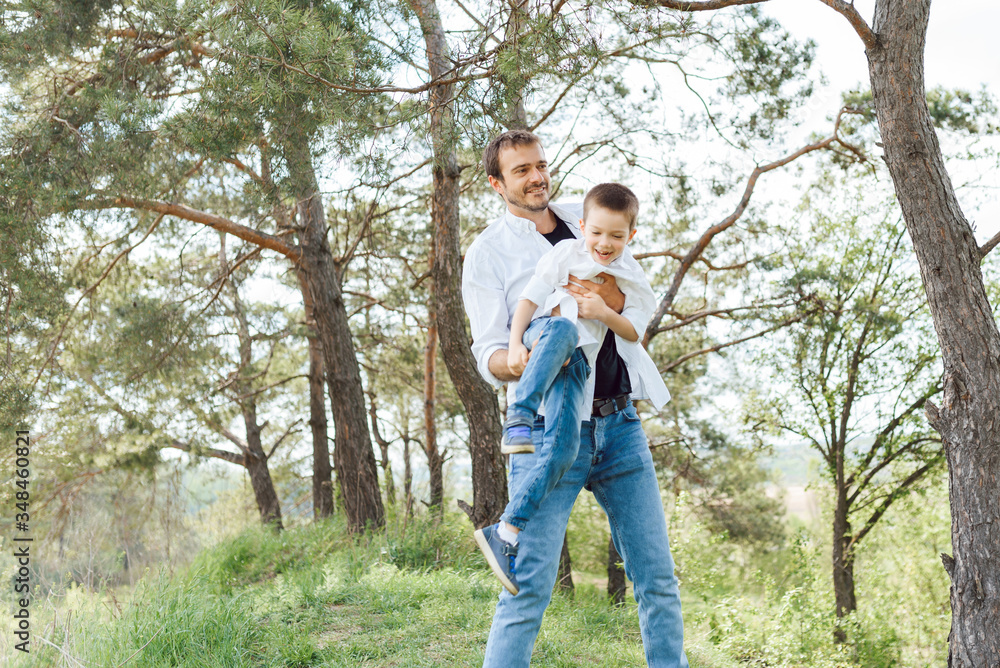 Happy time with father. Family fun concept. Bearded man and cute son Kids smile. Spring time walk with father. Happy time with father. Family fun concept. Bearded man and cute son Kids smile. Spring time walk with father.