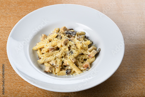 Traditional authentic italian penne al pollo e funghi pasta with mushroom ,chicken, parmesan cheese.