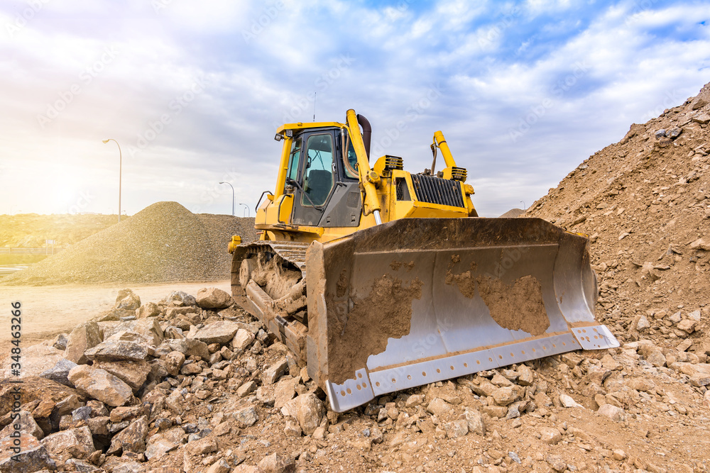 Excavator moving stone and rock at a construction site Excavator moving stone and rock at a construction site