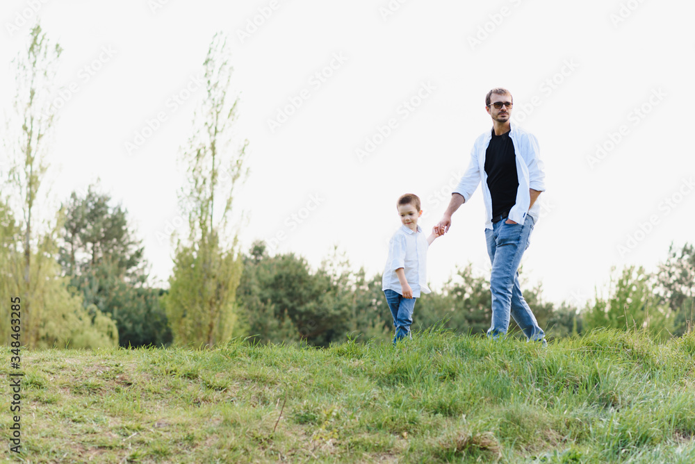 father and son have fun together in nature. Father and son playing. People having fun outdoors. Concept of friendly family. father and son have fun together in nature. Father and son playing. People having fun outdoors. Concept of friendly family.
