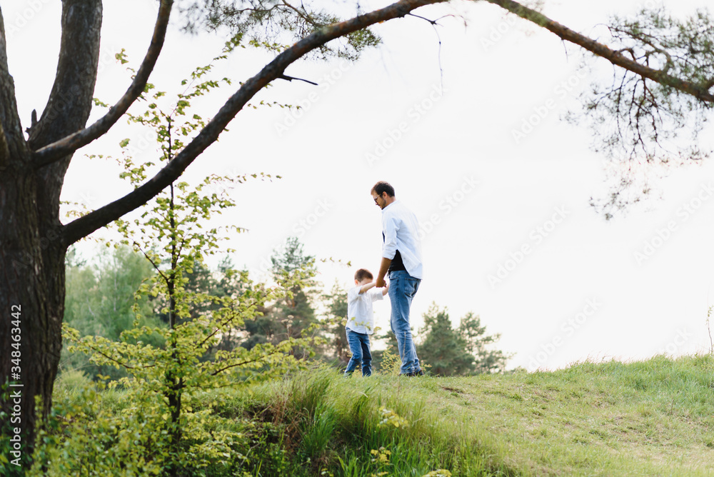 father and son have fun together in nature. Father and son playing. People having fun outdoors. Concept of friendly family. father and son have fun together in nature. Father and son playing. People having fun outdoors. Concept of friendly family.