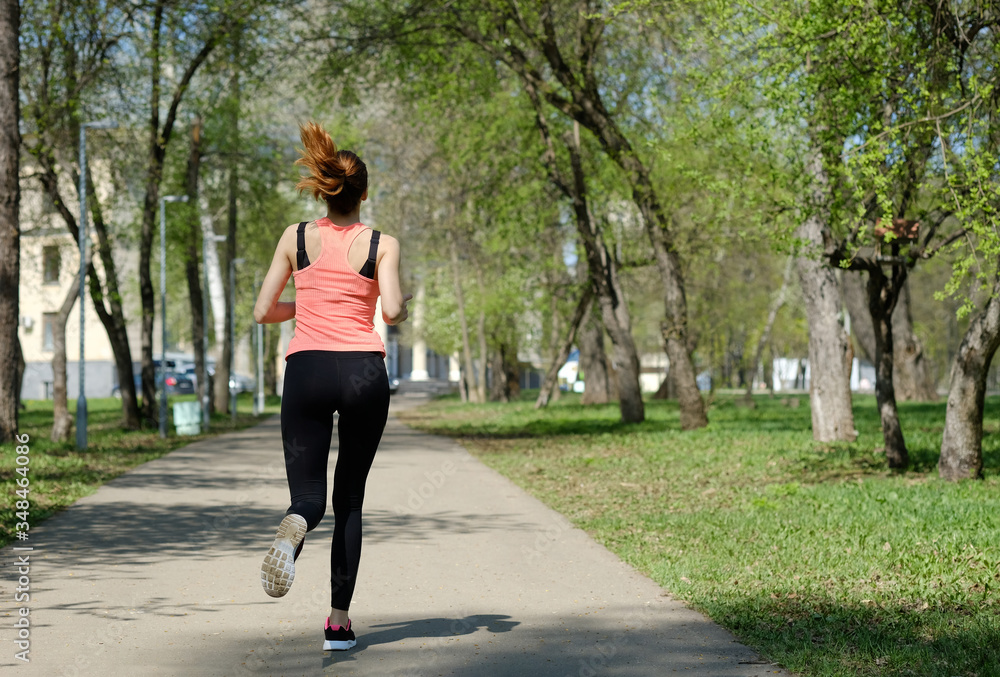 Young sporty woman jogging at park. Concept of healthy lifestyle and weight loss. Young sporty woman jogging at park. Concept of healthy lifestyle and weight loss.