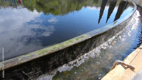 Working old treatment facilities. Reflection of the blue sky in the water.