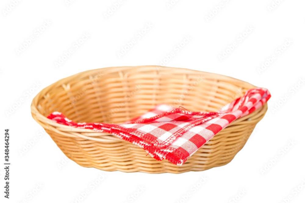 Obraz premium Wicker basket with red cotton napkin inside isolated on a white background
