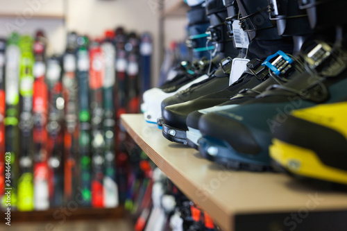 Different models of boots for alpine skiing on shelves in shop © JackF