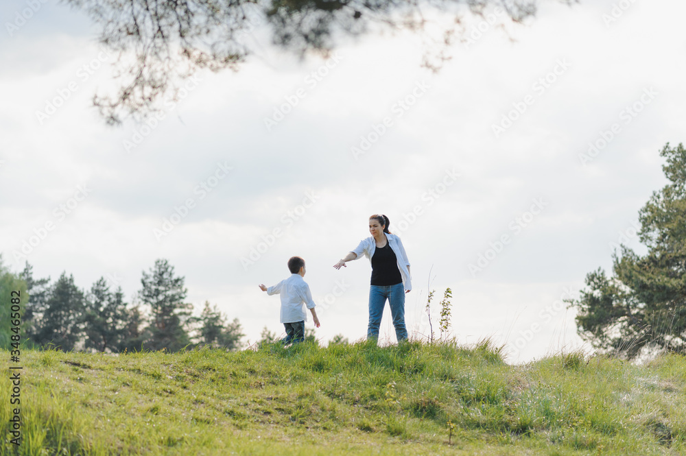 Stilish mother and handsome son having fun on the nature. Happy family concept. Beauty nature scene with family outdoor lifestyle. Happy family resting together. Happiness in family life. Mothers day. Stilish mother and handsome son having fun on the nature. Happy family concept. Beauty nature scene with family outdoor lifestyle. Happy family resting together. Happiness in family life. Mothers day.