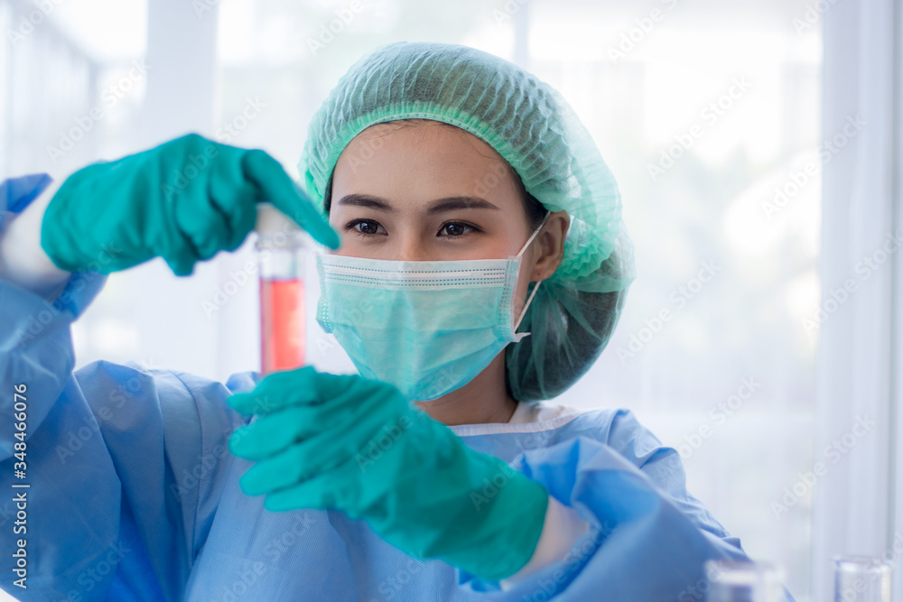 Asian Young woman scientist looking through a microscope in a laboratory. Young scientist doing some research. Asian Young woman scientist looking through a microscope in a laboratory. Young scientist doing some research.