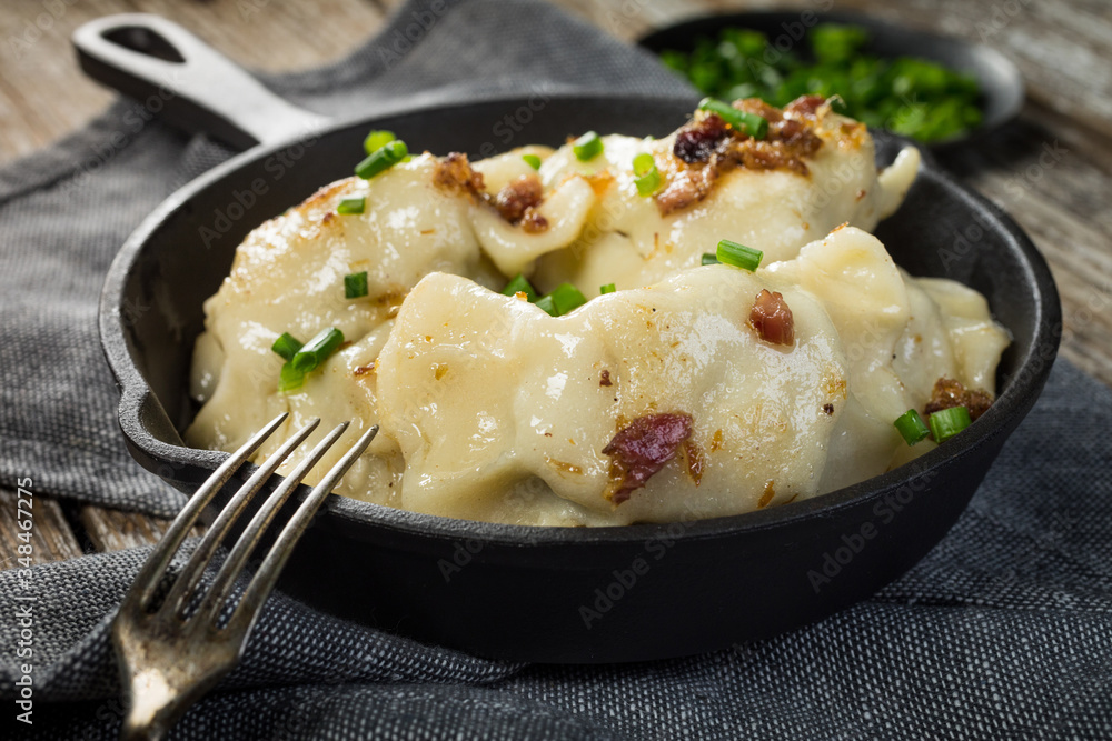 Fried dumplings (pierogi) with meat filling sprinkled with greaves. Fried dumplings (pierogi) with meat filling sprinkled with greaves.