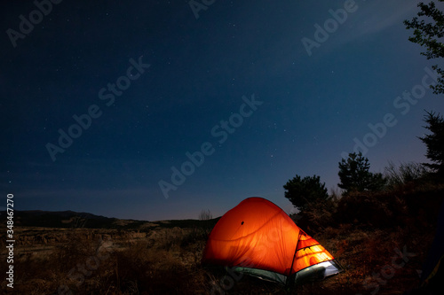Orange tent under the night sky