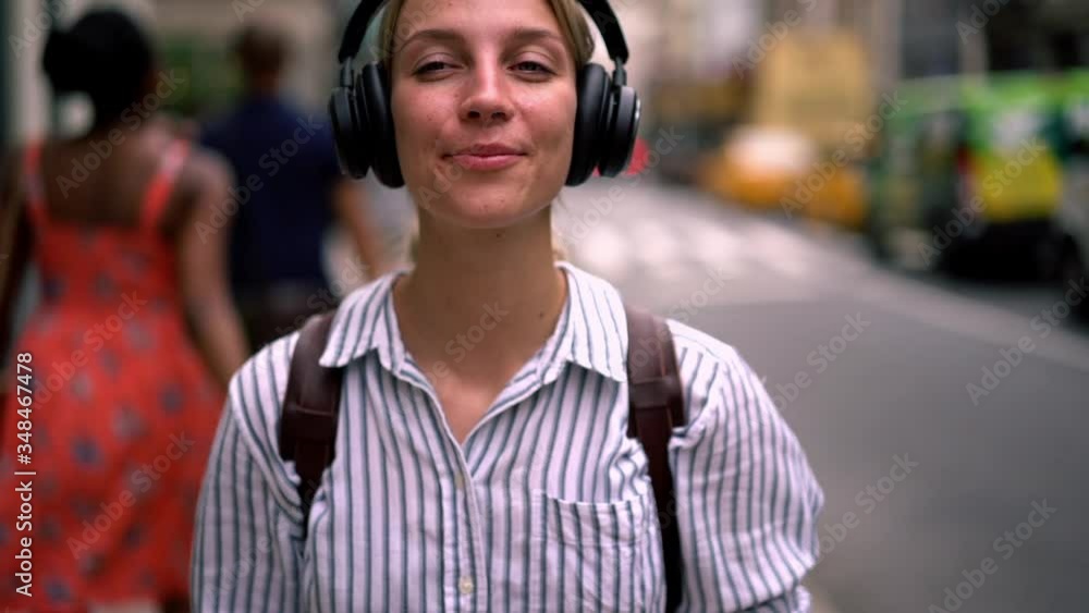 Slow motion of hipster blogger in casual wear walking on street and listening audio from musical app on smartphone.Young woman in modern headphones strolling in urban setting and enjoying playlist
Slow motion of hipster blogger in casual wear walking on street and listening audio from musical app on smartphone.Young woman in modern headphones strolling in urban setting and enjoying playlist