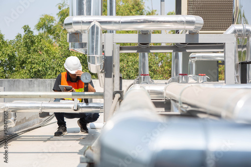 Engineers are checking the air cooled chiller, located on the roofs of the building.