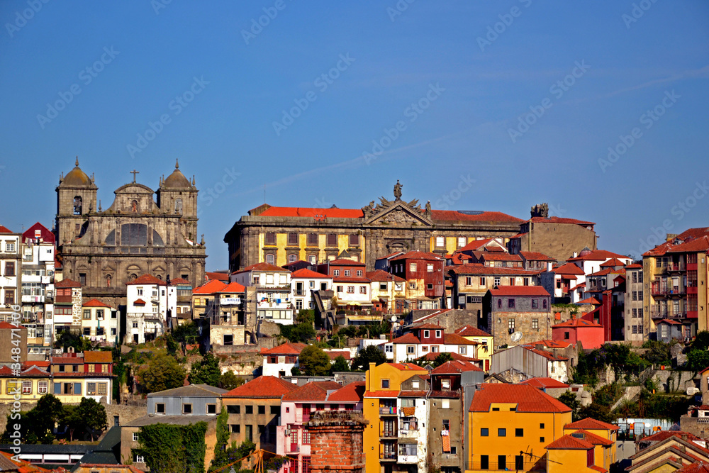 Porto, Portugal - August 17, 2015: Cityscape of Porto. Focus on a church and a big building beside.