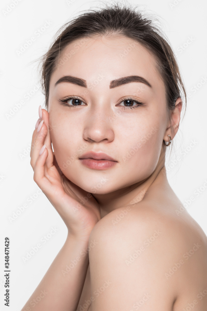 Fototapeta premium Beautiful face of a young woman with clean fresh skin isolated on white background. Skincare and body care concept.