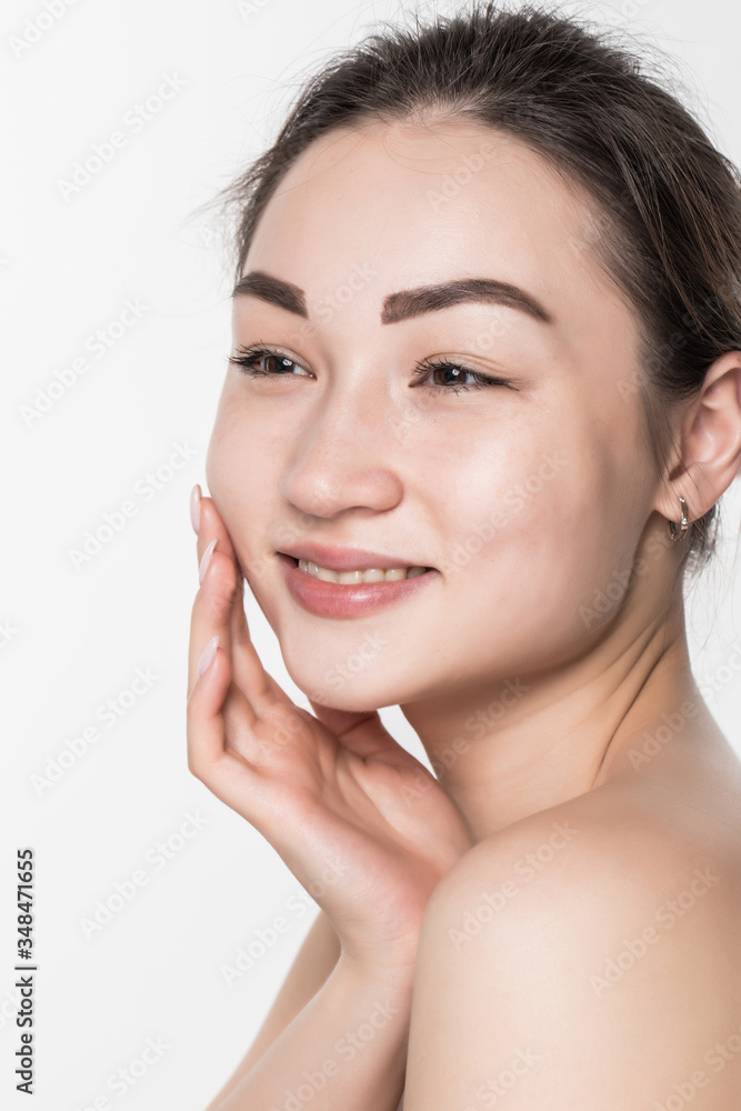 Beautiful face of a young woman with clean fresh skin isolated on white background. Skincare and body care concept.