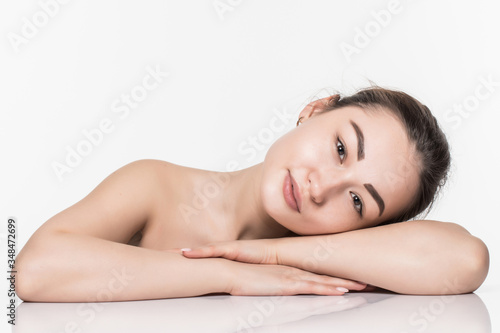 Beautiful face skincare beauty asian woman lying down with mirror reflection isolated on white background.