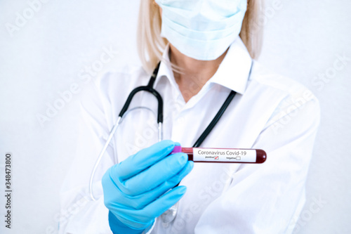 Coronavirus Covid-19 outbreaking. Medicine and epidemic concept. Tube with positive blood test result  protective face mask  medication pills  stethoscope  vial and syringe  vaccine in laboratory.