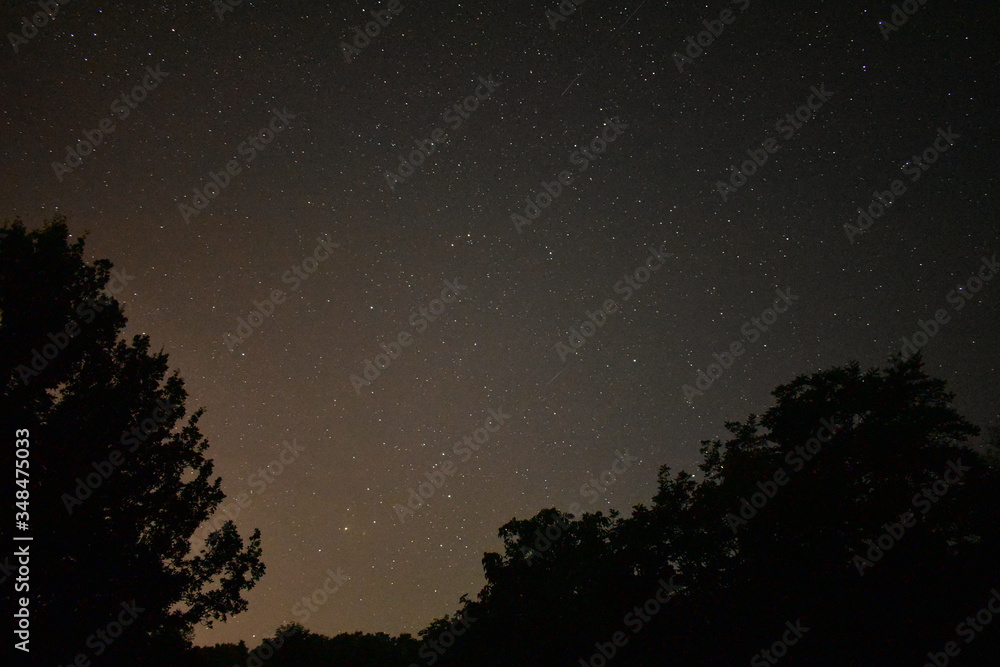 night sky with milky way galaxy shining trough stars and planets