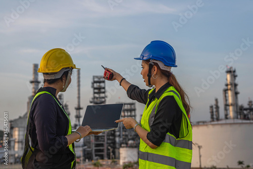White woman engineer, logistics and transportation business of gas and oil with background of oil and gas refinery, import, export and transportation in the industry