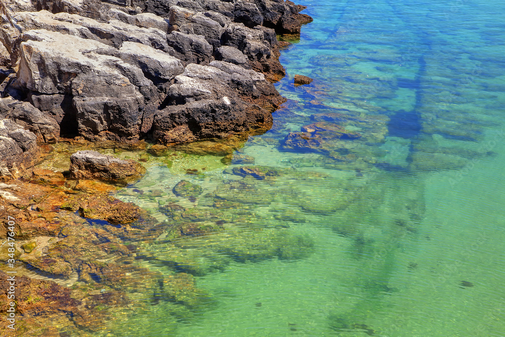 coastal rock formation , transparent ocean water