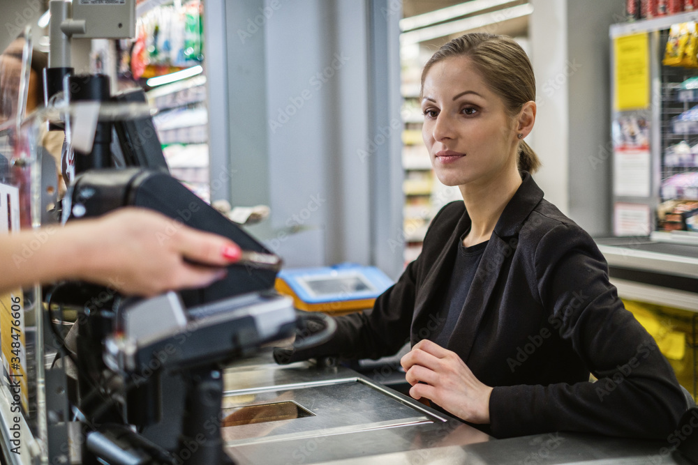 Paying with ca smartphone in a grocery store Paying with ca smartphone in a grocery store