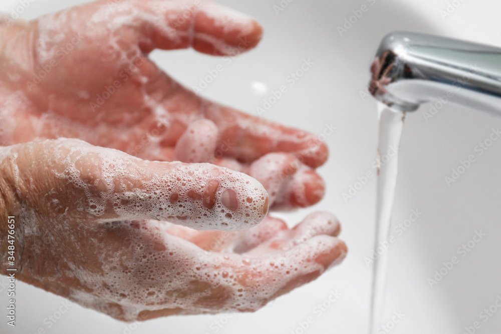 Fototapeta premium Washing hands under the water tap with soap