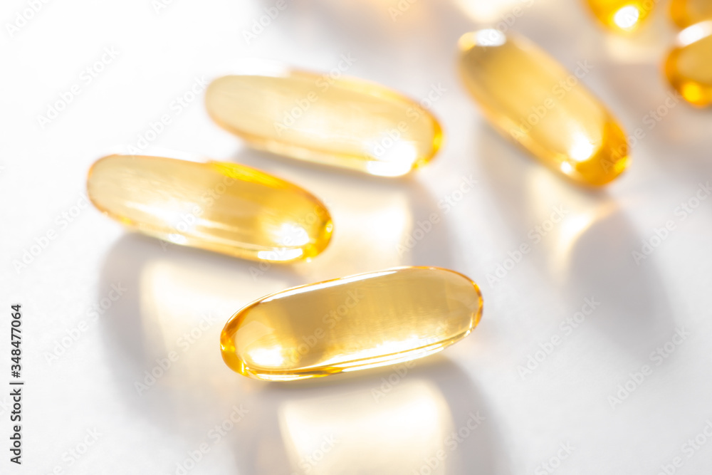 Close-up on cod liver oil capsules on white background Close-up on cod liver oil capsules on white background