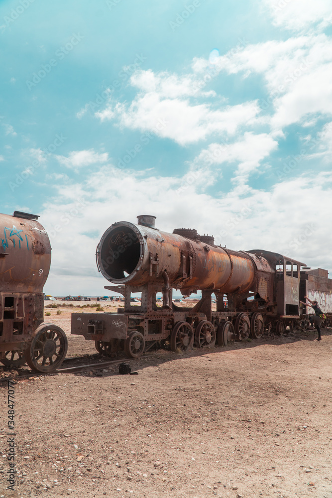 Train Cemetry Bolivia Salt Flats. Bolivian salty desert and blue sky background. Shot in Salar de Uyuni. Rusted, waste, abandoned, locomotive graveyard, railroad concepts. Tourist attraction Train Cemetry Bolivia Salt Flats. Bolivian salty desert and blue sky background. Shot in Salar de Uyuni. Rusted, waste, abandoned, locomotive graveyard, railroad concepts. Tourist attraction