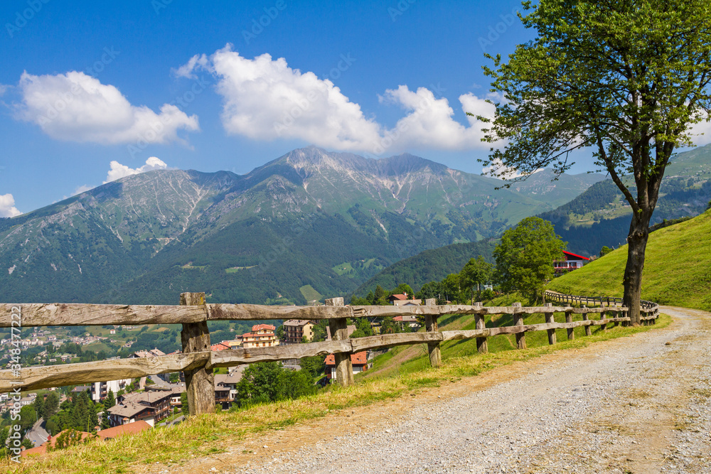 View of a sunny day on Italian Alps in summer time. Blue sky over the panorama